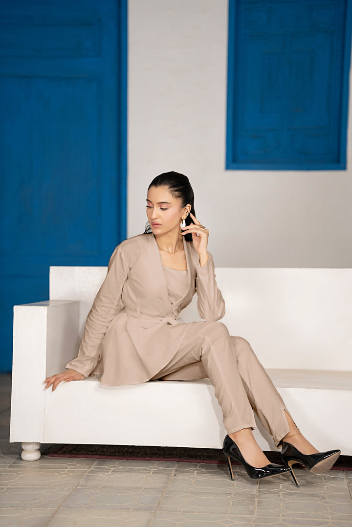Model posing in Sandora sand belted frock co-ord set with relaxed straight trousers and front slits